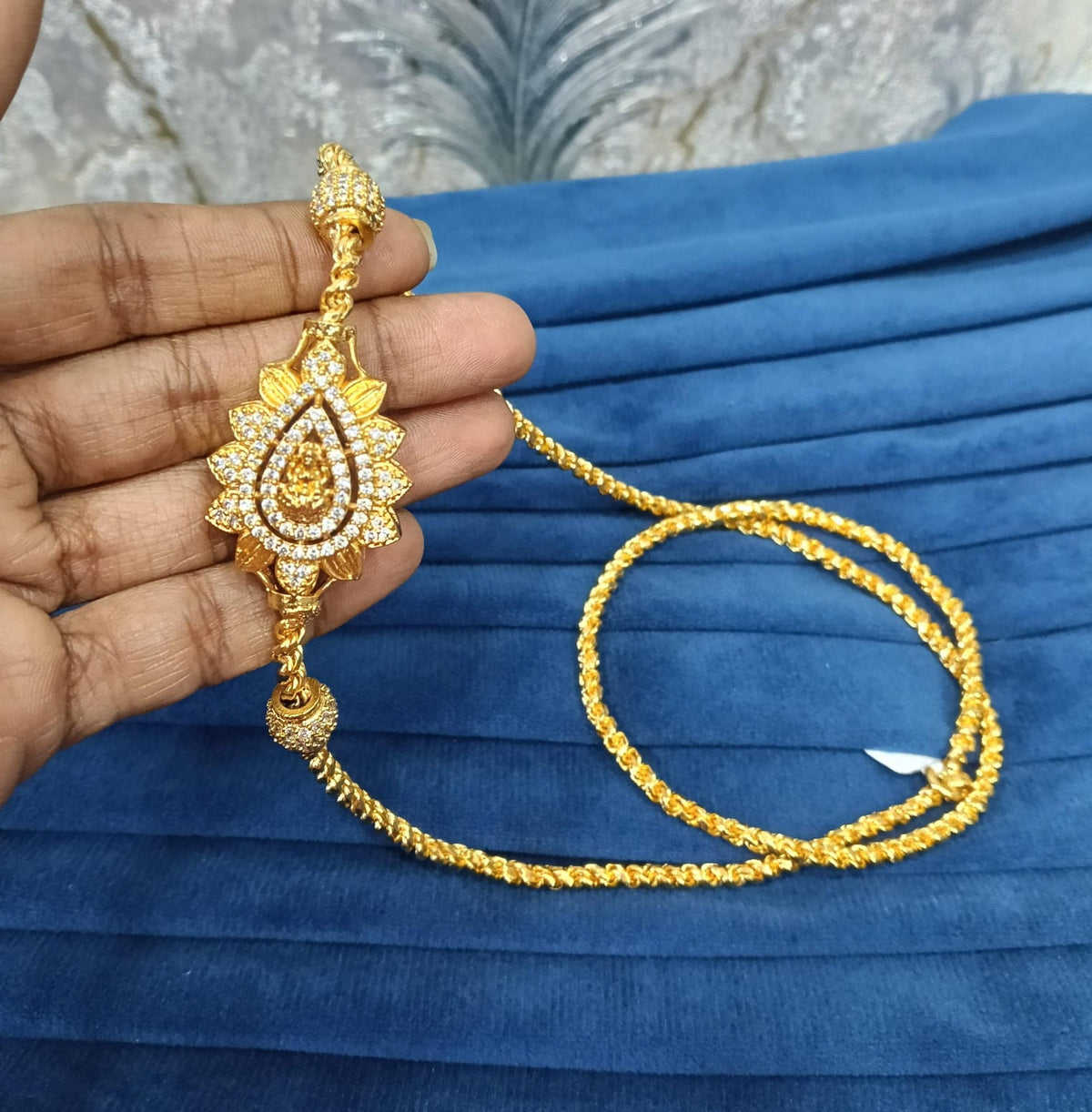 Gold look mugappu chain.