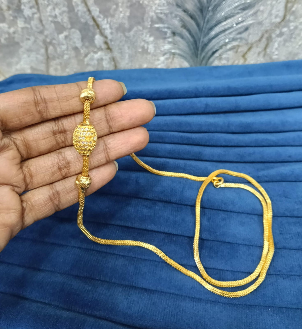 Gold look mugappu chain.