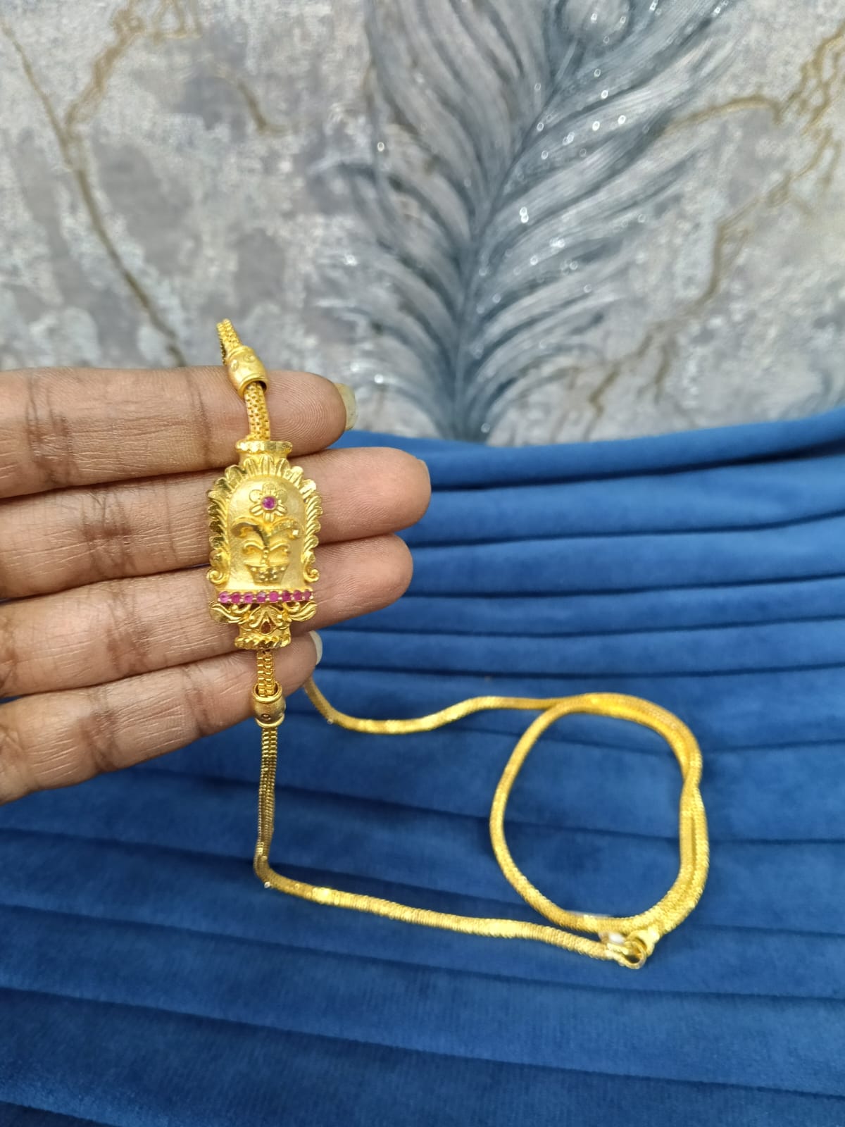 Gold look mugappu chain.