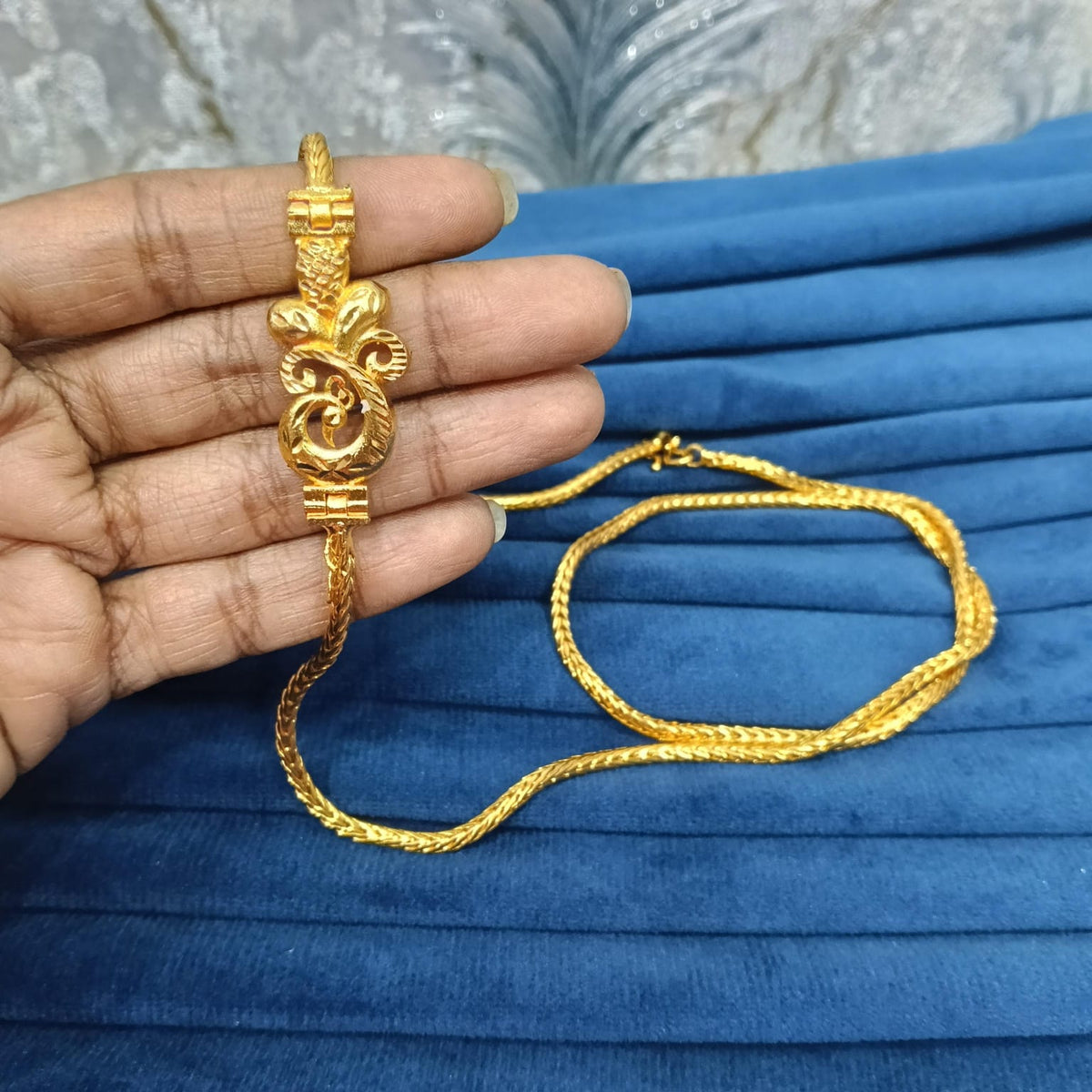 Gold look mugappu chain.