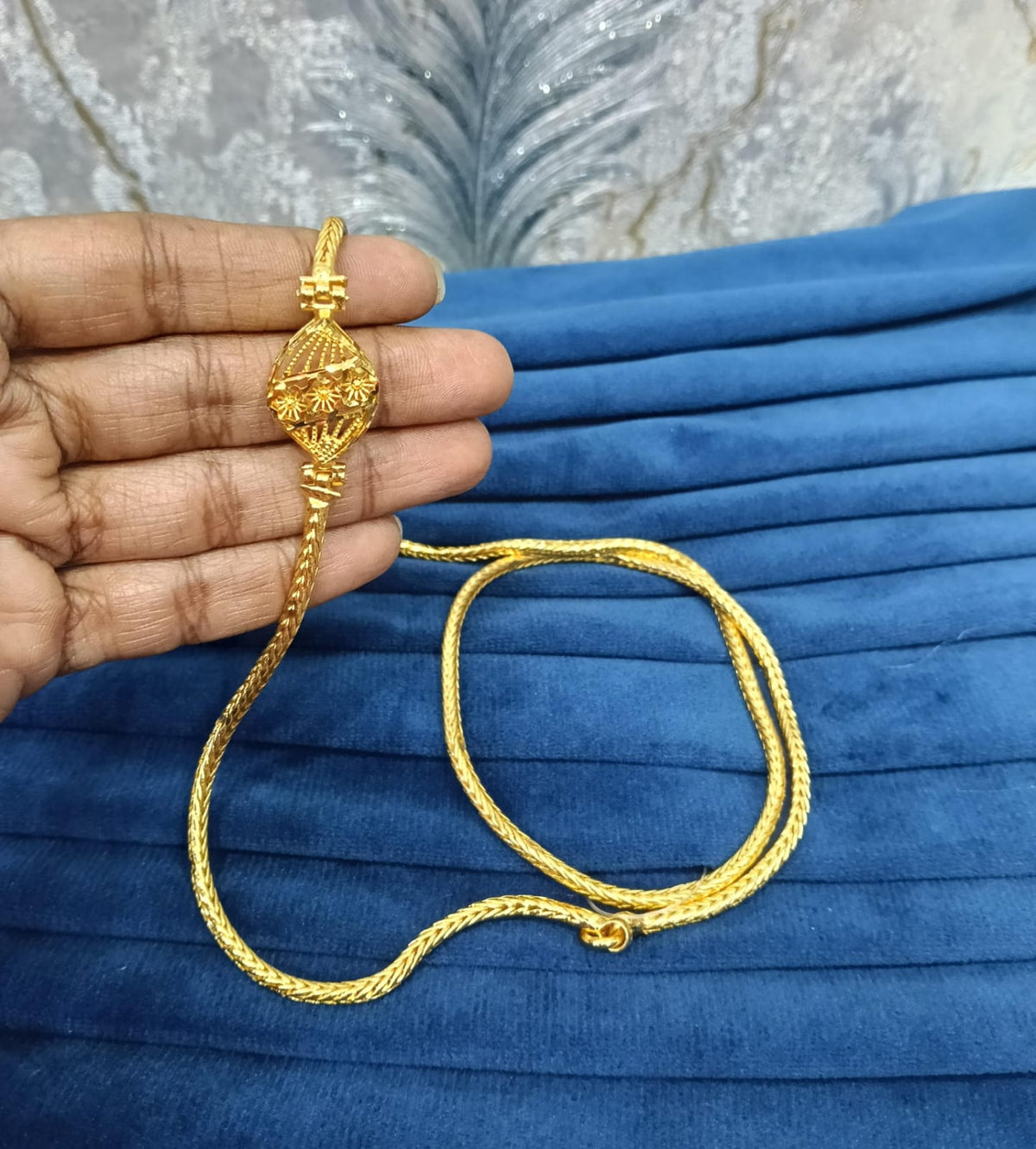 Gold look mugappu chain.
