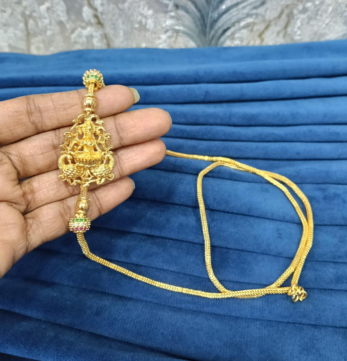 Gold look mugappu chain.