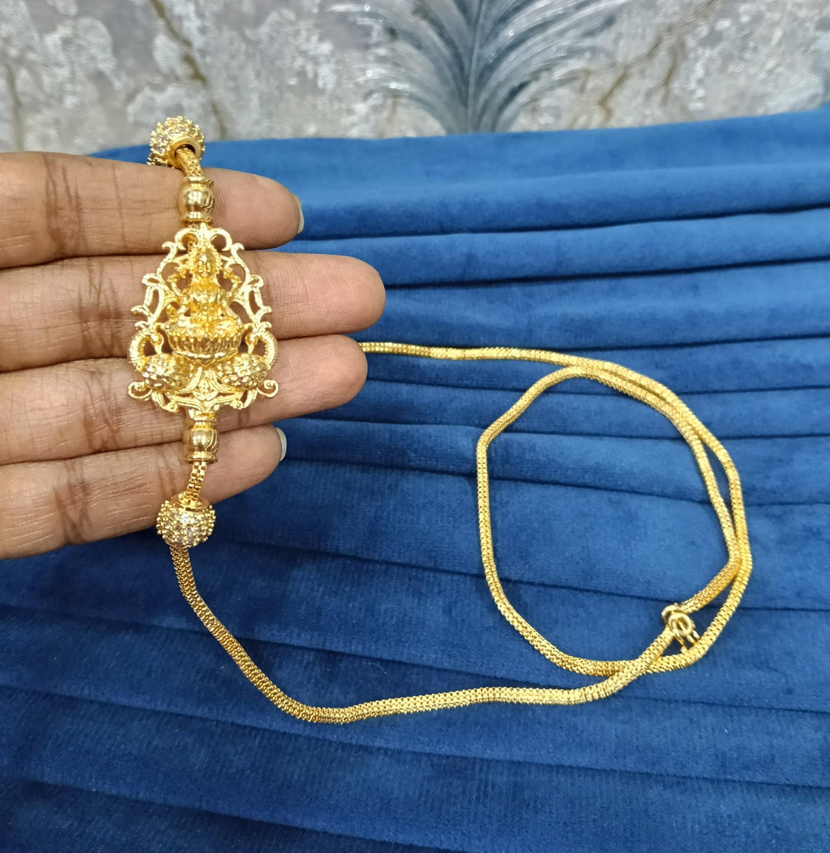 Gold look mugappu chain.