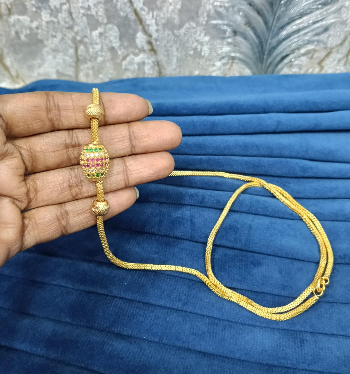 Gold look mugappu chain.