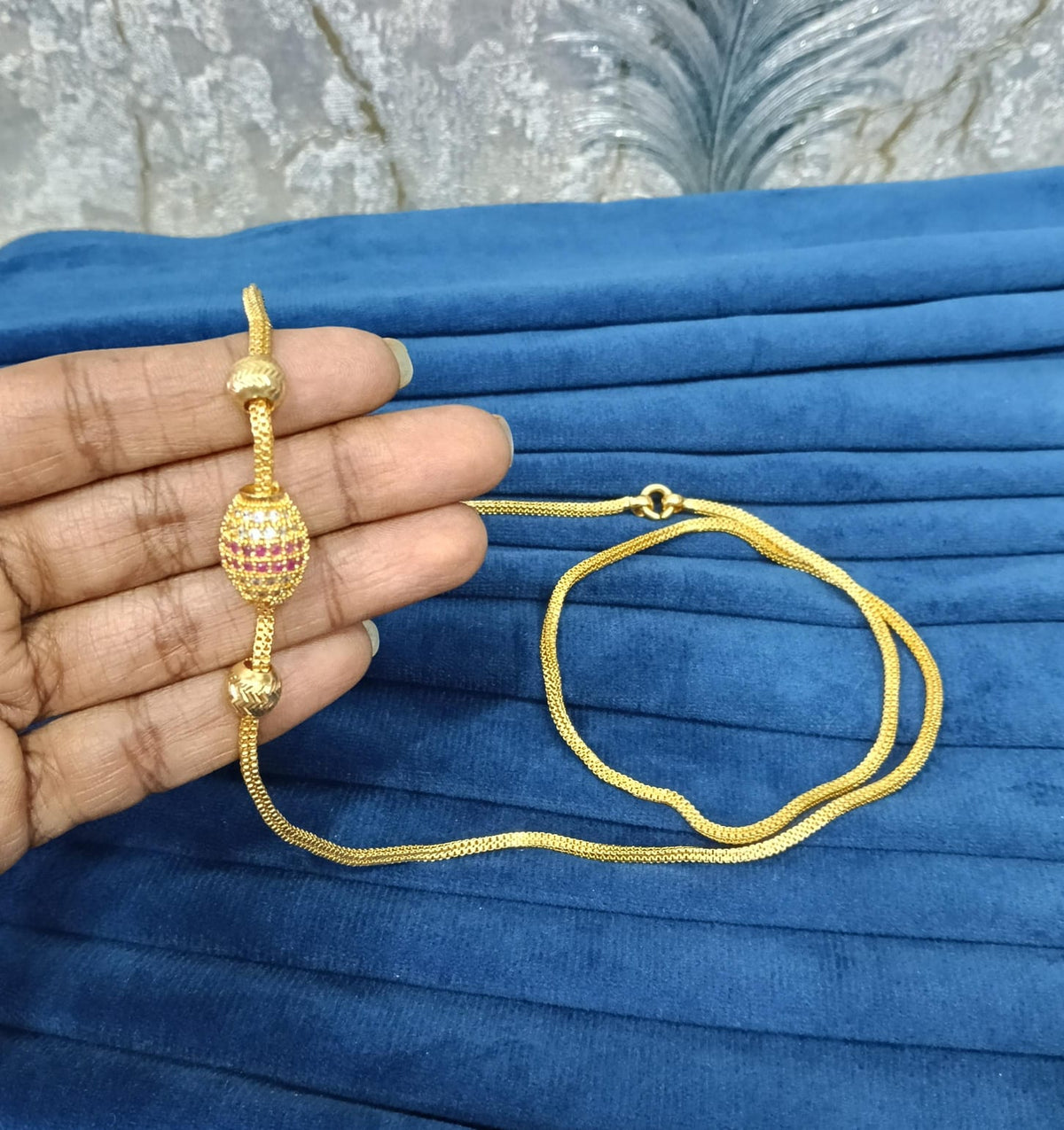 Gold look mugappu chain.
